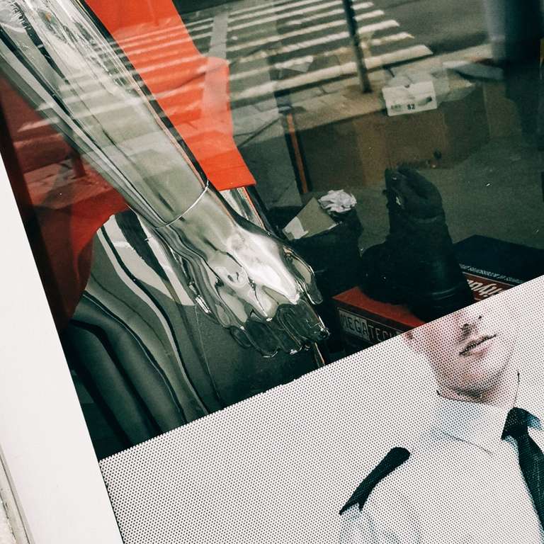 Mannequin in a shop window with a hand