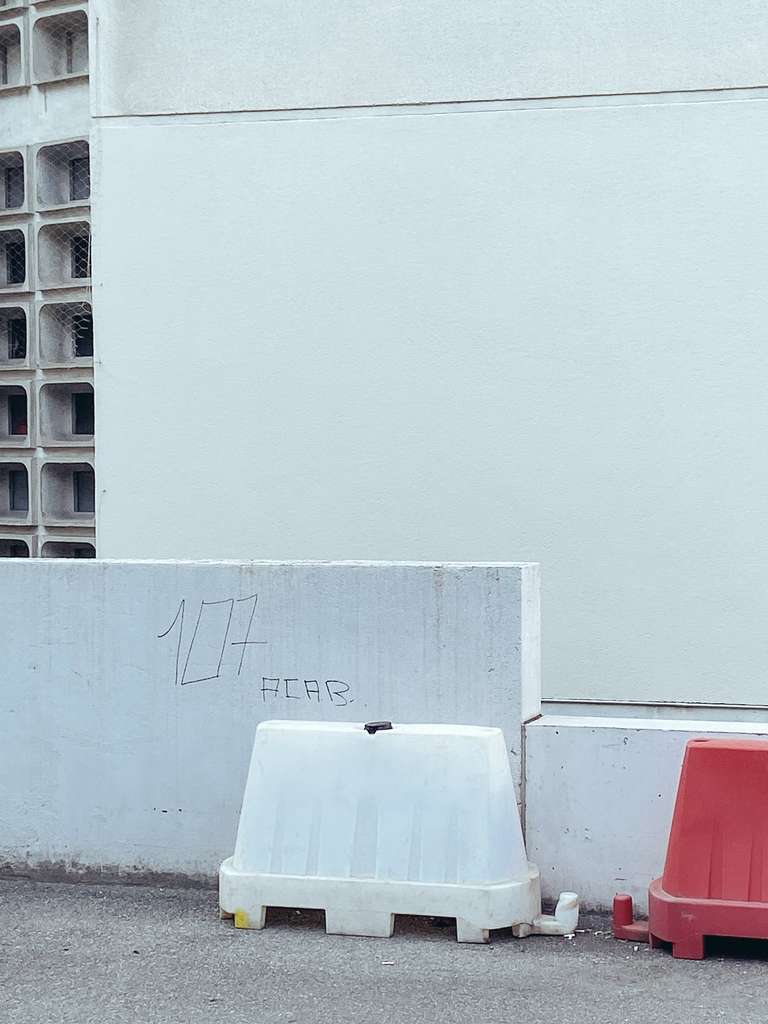 traffic cone in front of a wall
